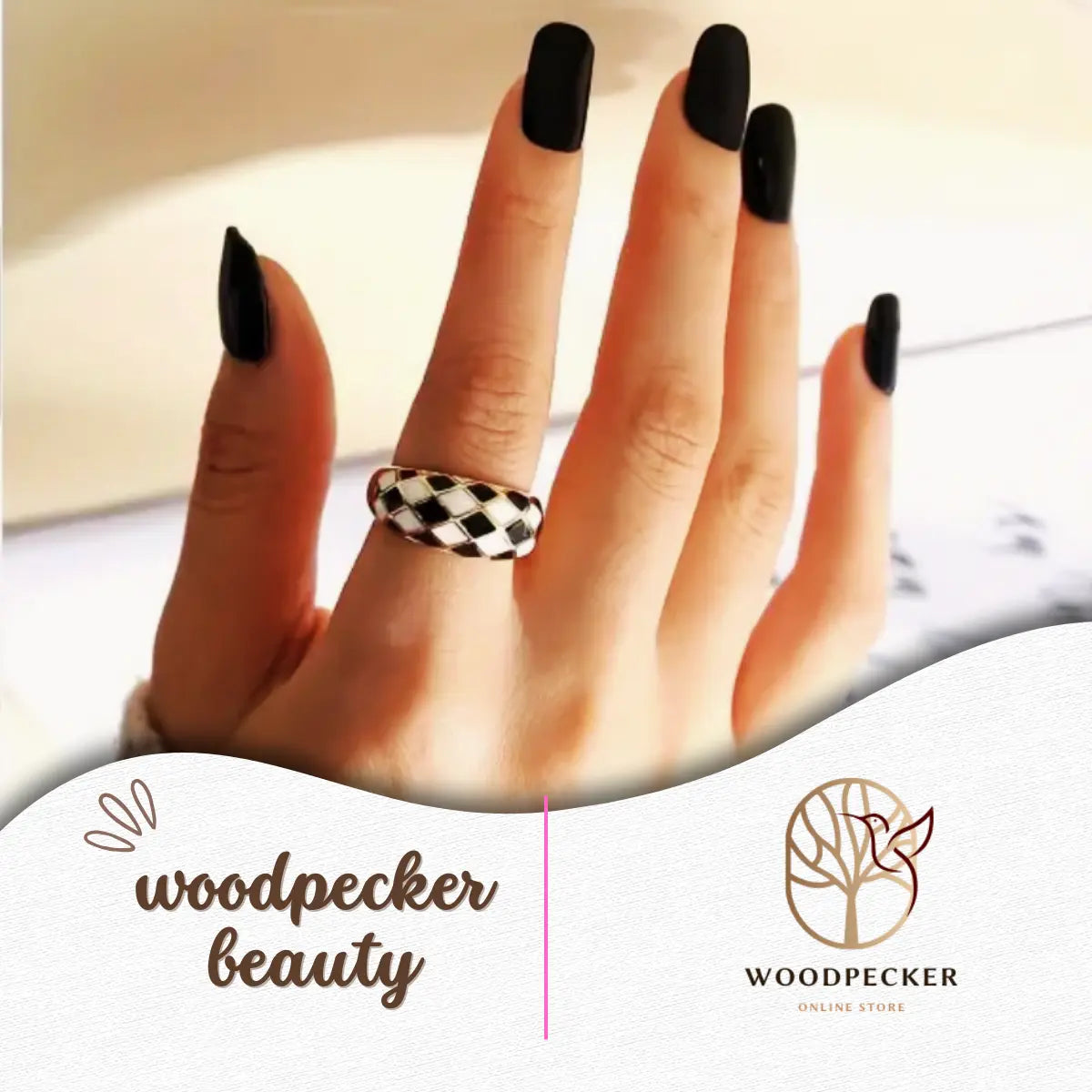 Woman’s hand wearing bold solid black nail stickers, captured from a straight angle