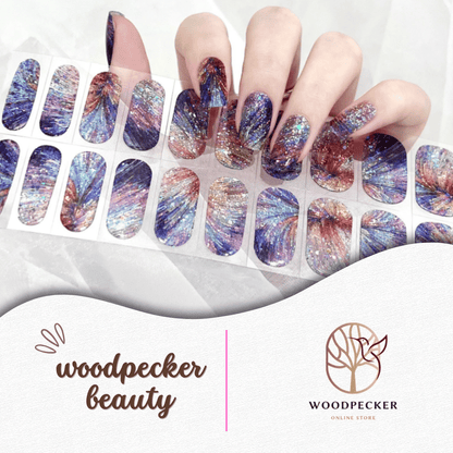 Colorful glitter nail stickers with firework-inspired starburst designs in blue, red, and gold tones.
