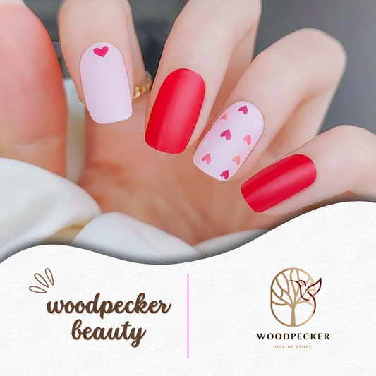 Red and pink heart-themed nail wraps with matte and glossy mix finish on hand